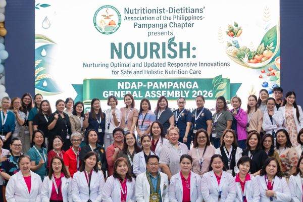 A large group of smiling Registered Nutritionist-Dietitians and a LeadSmart PH speaker posing together at the NDAP Pampanga Chapter General Assembly 2026 venue.