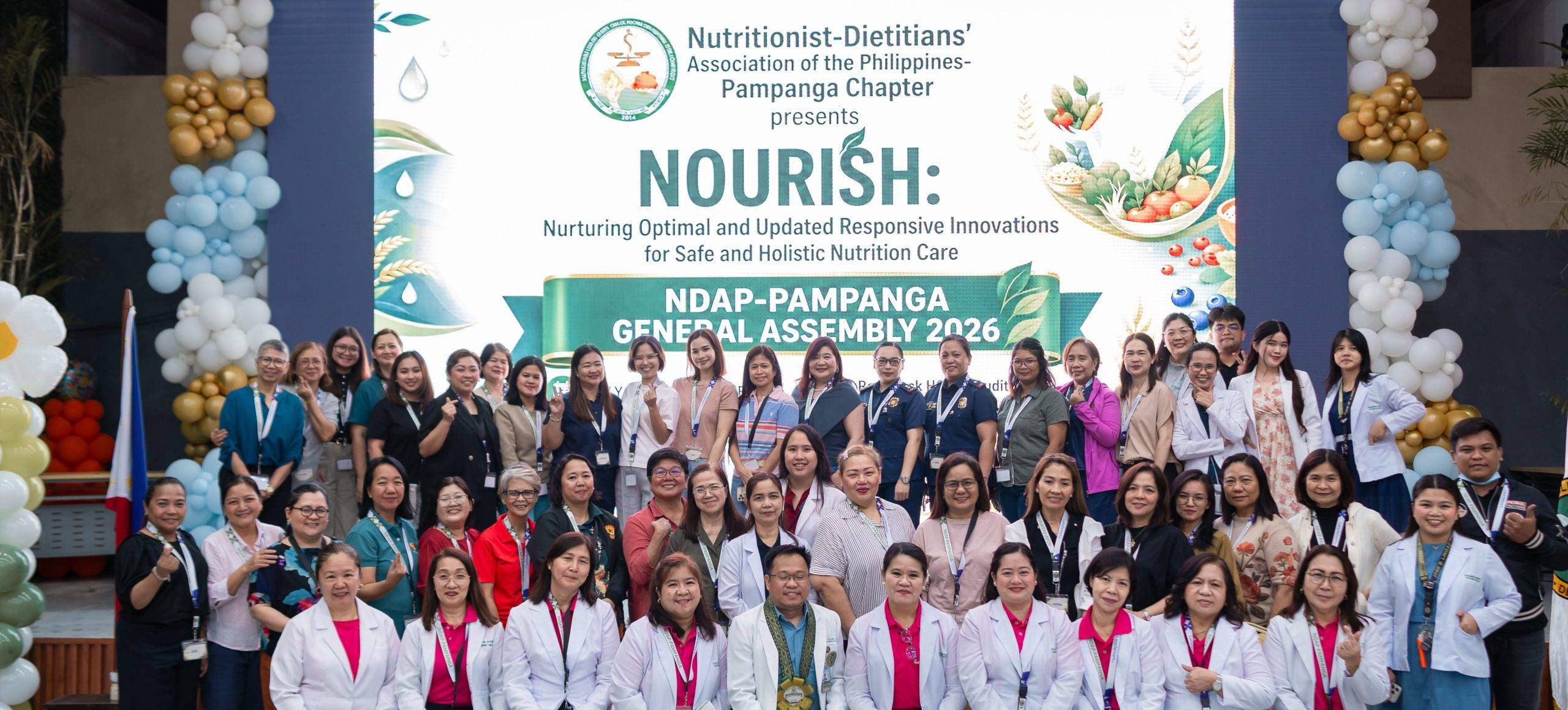 A large group of smiling Registered Nutritionist-Dietitians and a LeadSmart PH speaker posing together at the NDAP Pampanga Chapter General Assembly 2026 venue.